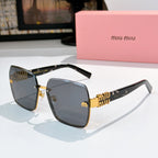 Sunglasses with gray lenses, dark frame, and gold chain-style temple detail