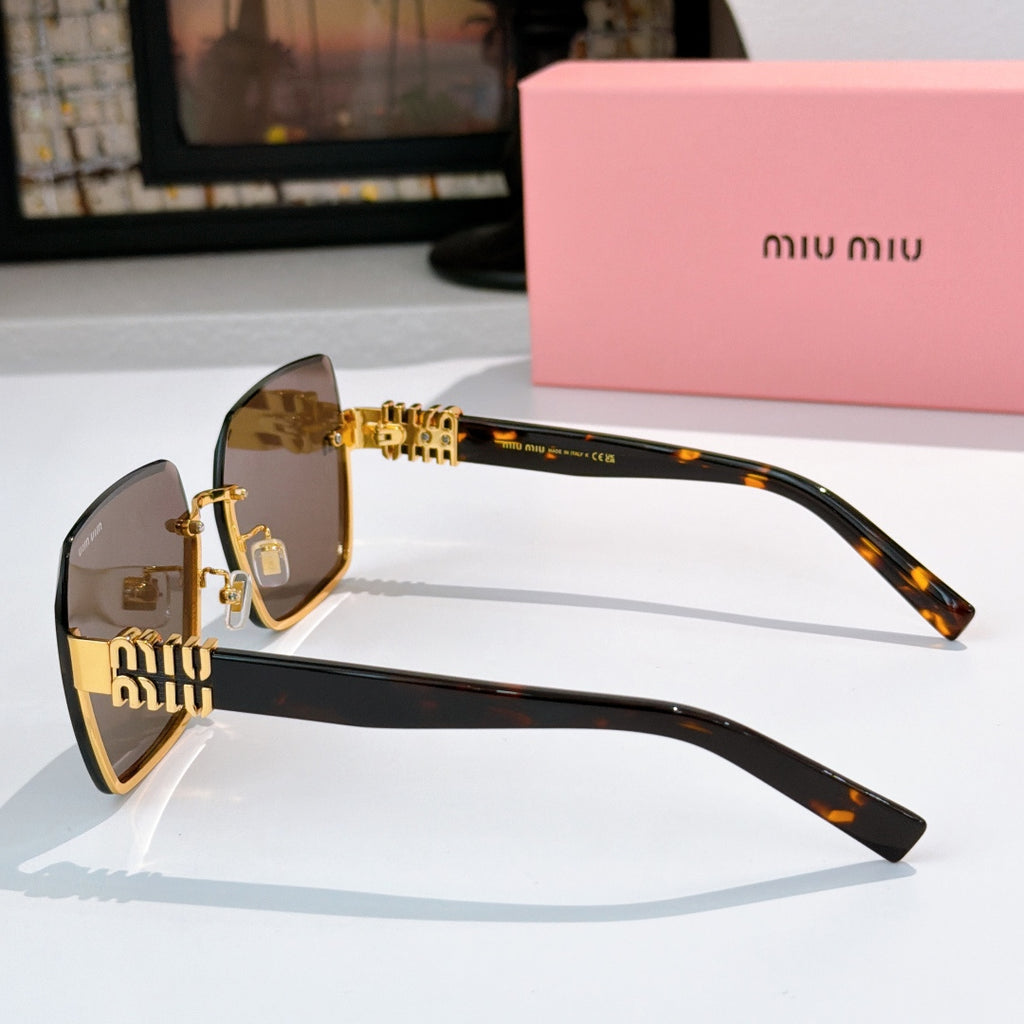 Sunglasses with brown lenses, tortoise temples, and gold chain-style center detail