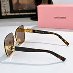 Sunglasses with brown lenses, tortoise temples, and gold chain-style center detail