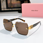 Sunglasses with dark brown lenses, tortoise temples, and gold chain-style hinges