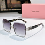 Sunglasses with dark lenses, tortoise temples, and gold logo hardware detail