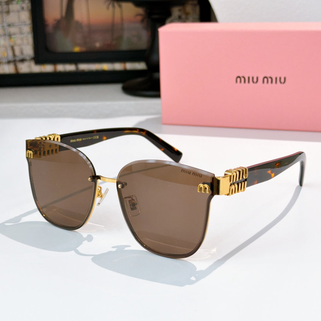 MiuMiu glasses with gold cat-eye frames and dark brown lenses