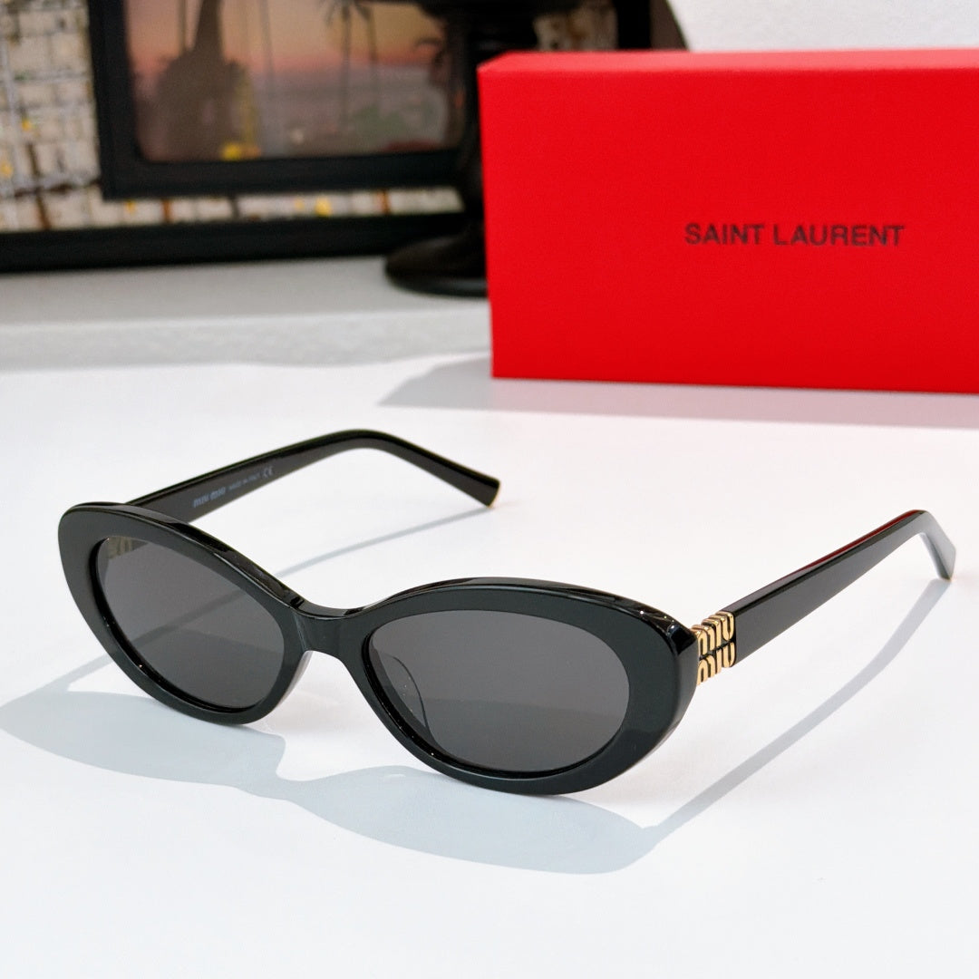MiuMiu cat-eye sunglasses with black frame and dark lenses, gold logo detail