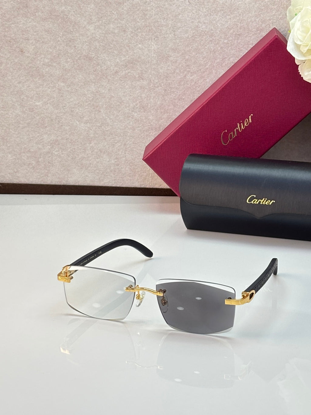Cartier eyeglasses with black frames and dark smoky gradient lenses, gold accents