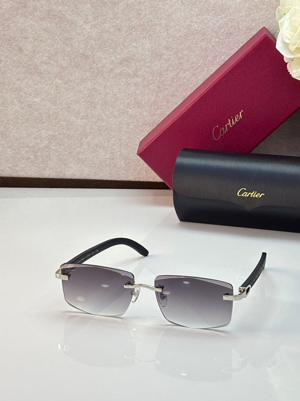 Cartier eyeglasses with black rectangular frames and gray gradient lenses, gold accents