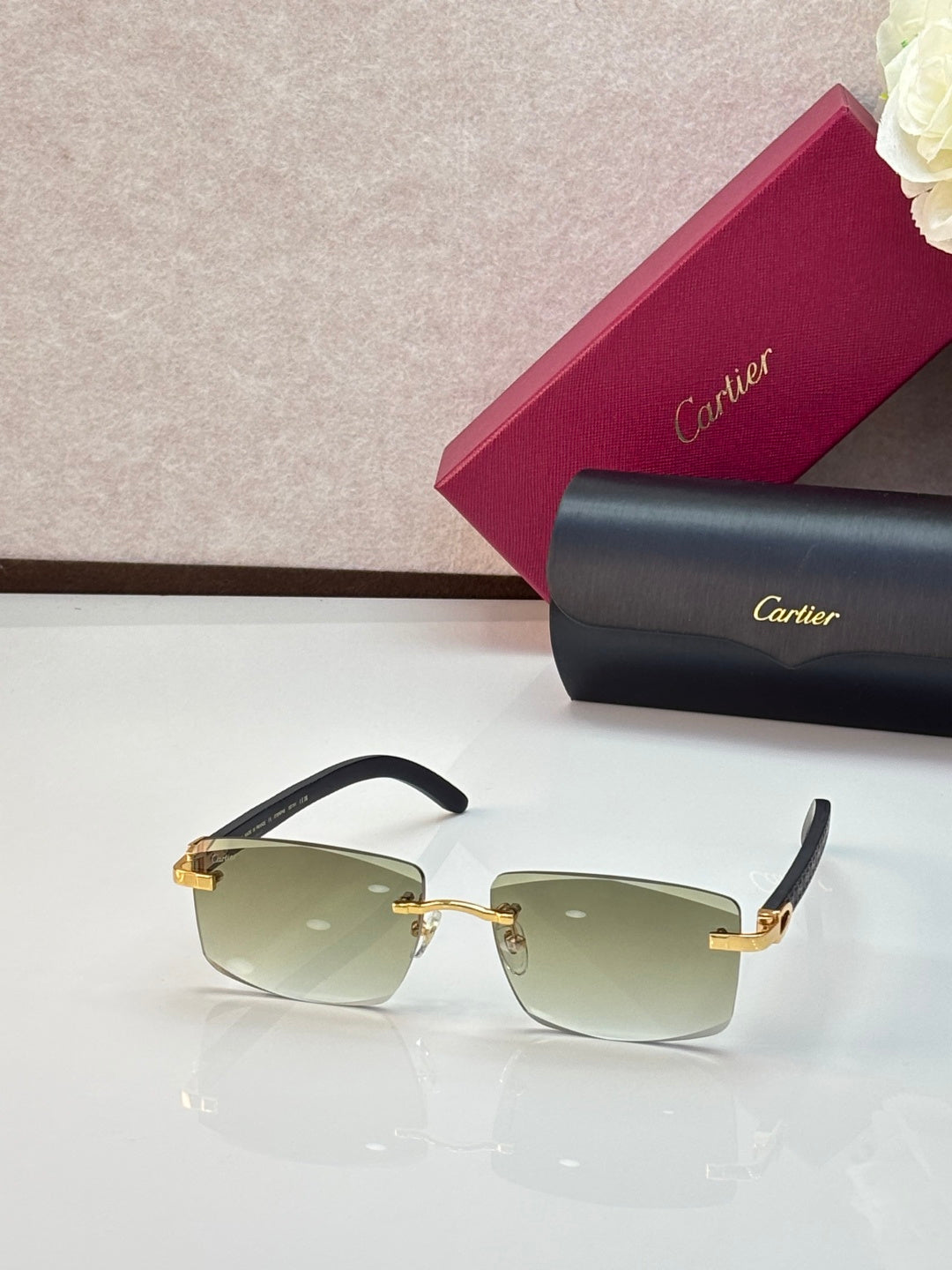 Cartier eyeglasses with gold frames and light green gradient lenses, gold accents
