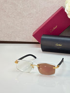 Cartier eyeglasses with tan frames and brown-orange gradient lenses, gold accents