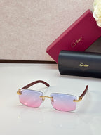 Cartier eyeglasses with dark brown frames and pink gradient lenses, gold accents