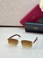 Cartier eyeglasses with tan frames and amber gradient lenses, gold accents