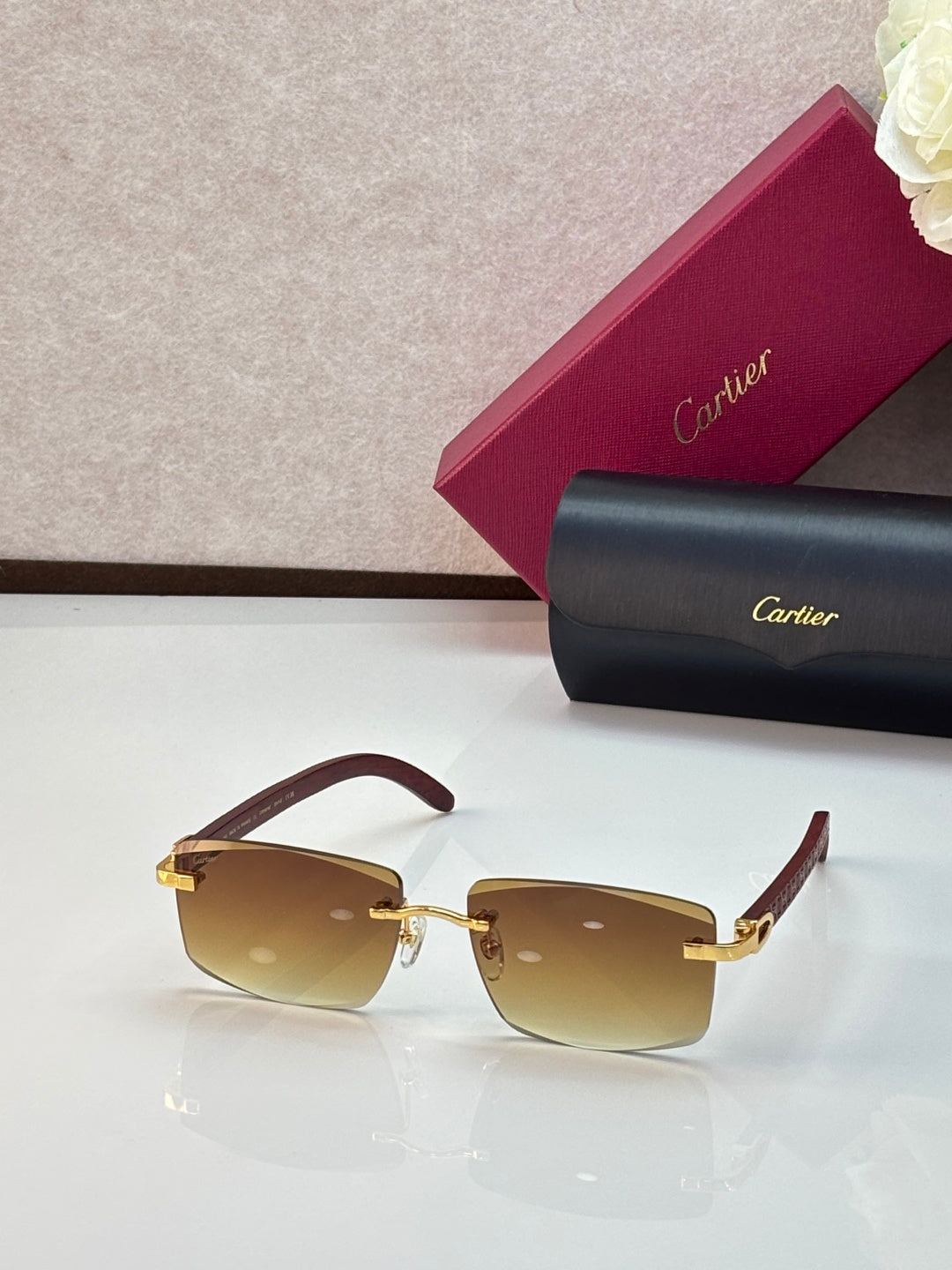 Cartier eyeglasses with tan frames and amber gradient lenses, gold accents