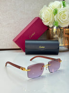 Eyeglasses with pink-tinted lenses, dark frames, and gold-tone temples