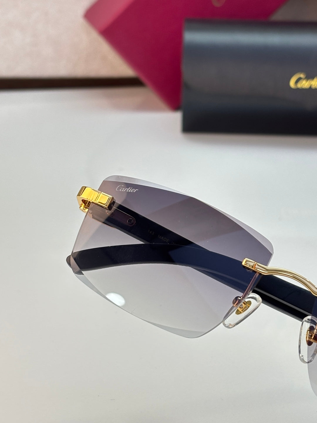 Oversized eyeglasses with dark-tinted lens, gold frame, and dark temples