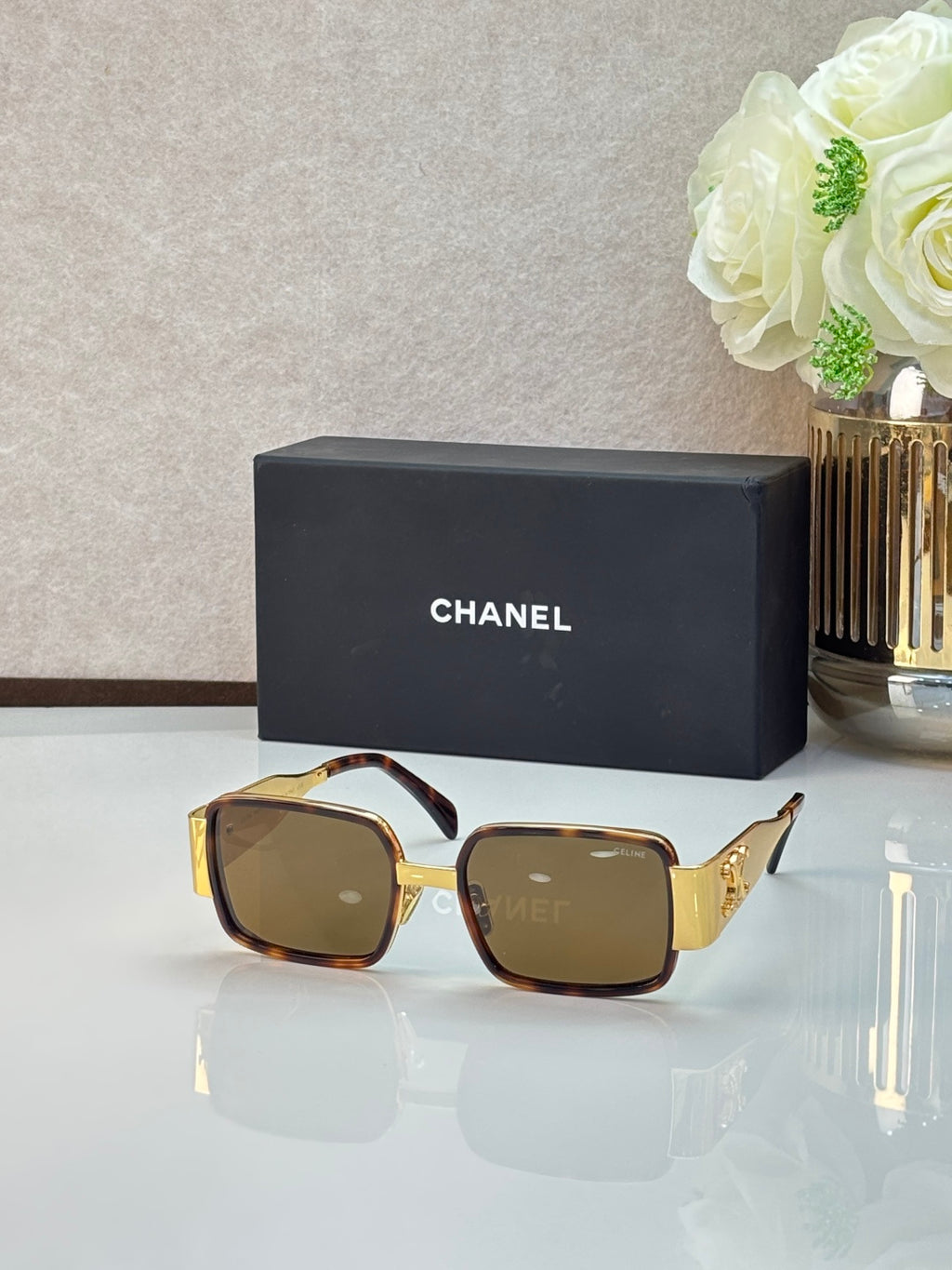 Celine glasses with gold-tone frames, brown lenses, and black temples