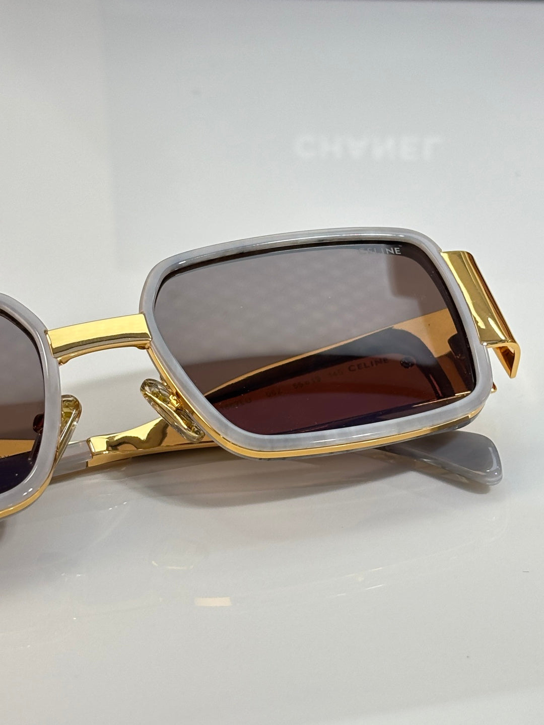 Celine glasses close-up with gold-tone frame and brown lens panel