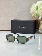 Celine glasses with dark rectangular frames, green-tinted lenses, and gold logo detail