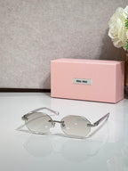 MiuMiu clear-lens round sunglasses with silver arms and thin frames