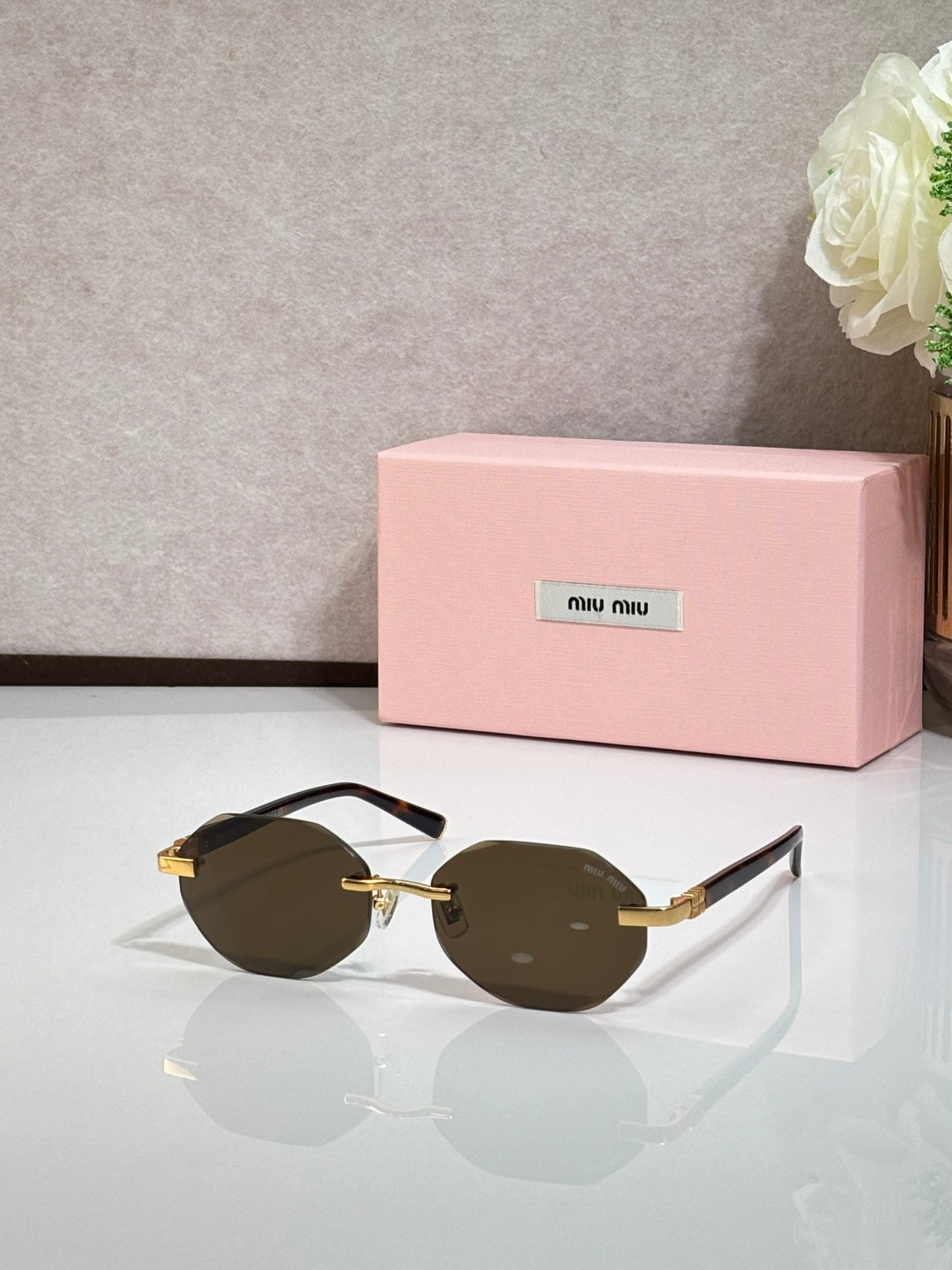 MiuMiu dark-brown round sunglasses with gold arms and tinted lenses