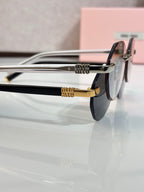 MiuMiu silver round sunglasses close-up with gold hinge and logo detail
