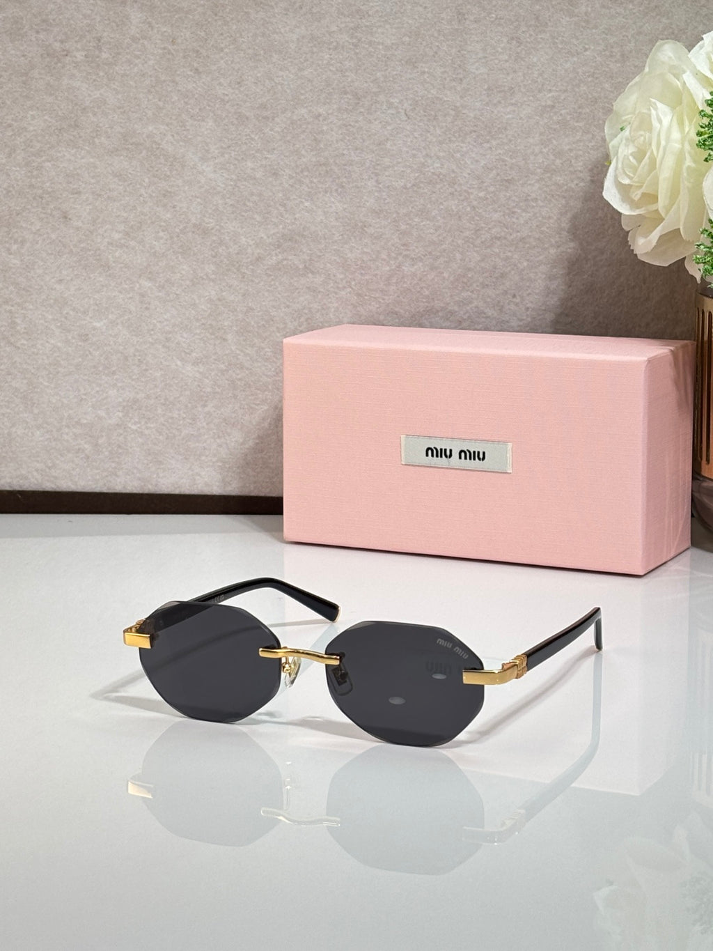 MiuMiu black round sunglasses with gold arms and dark lenses