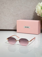 MiuMiu rose-tinted round sunglasses with gold arms and light frames