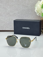 Chanel sunglasses with gold frames and dark green tinted lenses