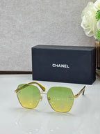 Chanel sunglasses with gold frames and yellow-green tinted lenses