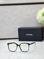Chanel eyeglasses with black square frames and light lenses, silver-tone logo temples