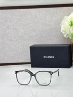 Chanel eyeglasses with black square frames and clear lenses, silver-tone logo temples