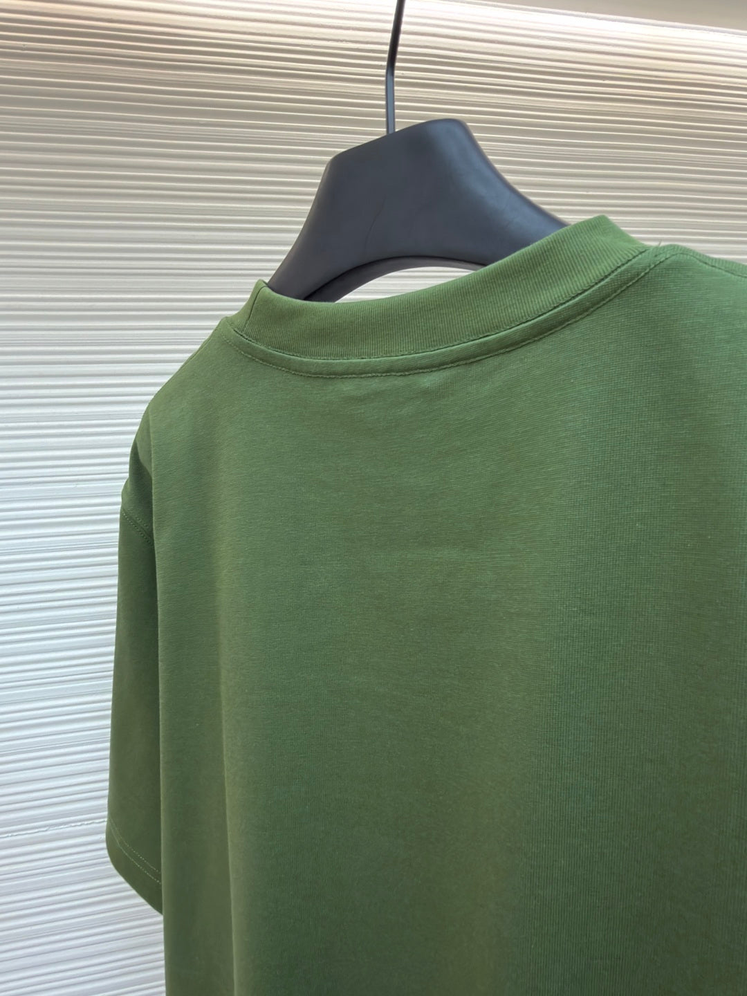 Green T-shirt back view on hanger, crew neck