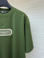 Green T-shirt side view with Christian Dior Couture logo patch