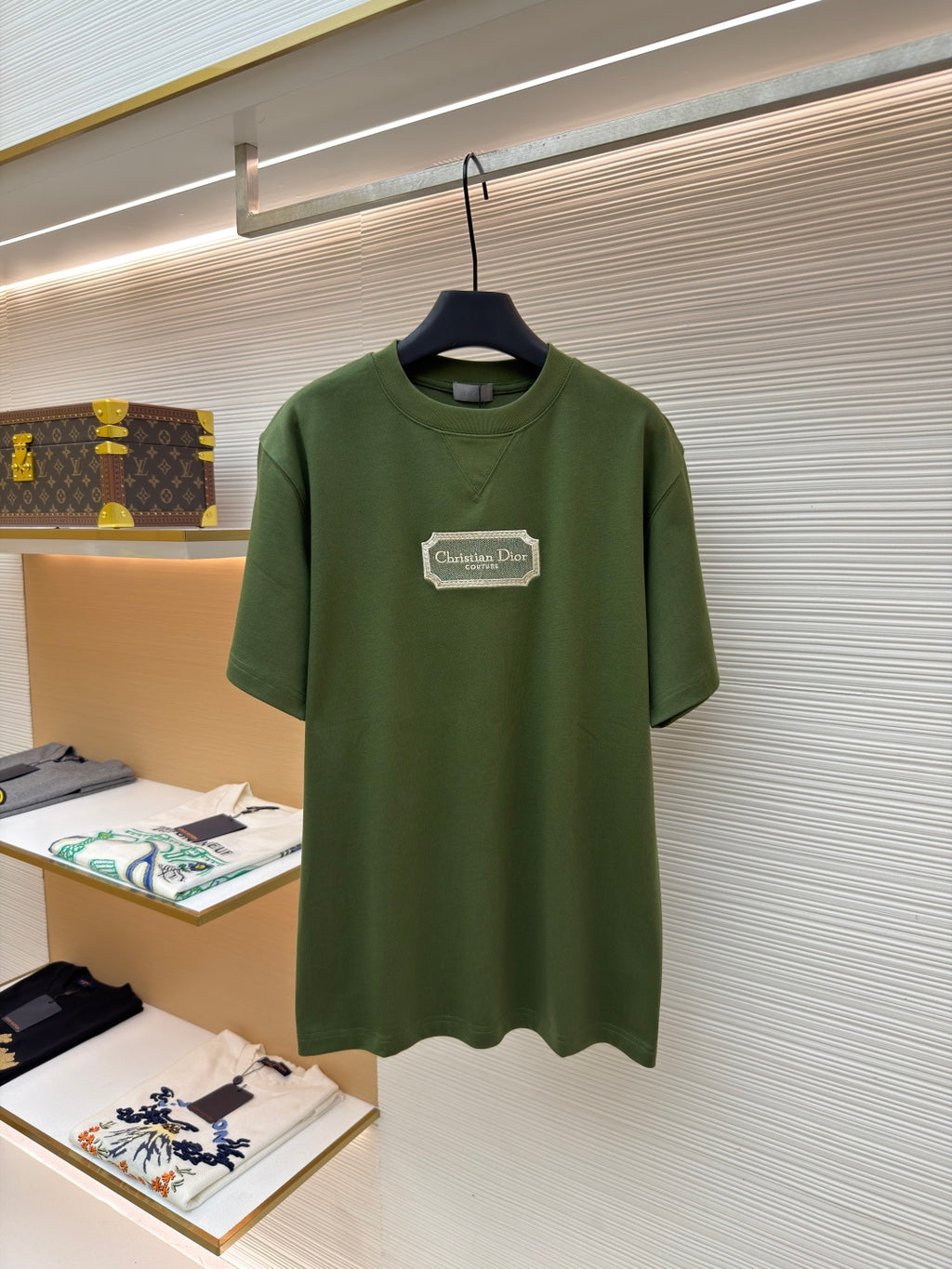 Green T-shirt with Christian Dior Couture logo patch on chest