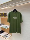 Green T-shirt with Christian Dior Couture logo patch on chest
