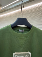 Green T-shirt close-up with Christian Dior Couture chest label