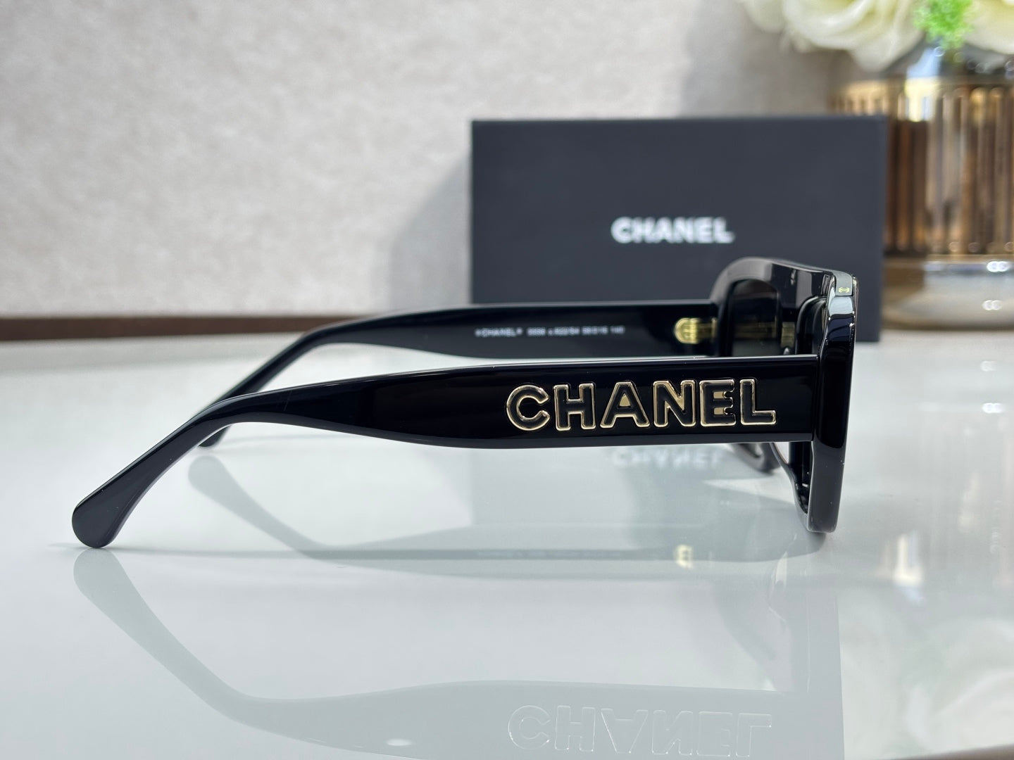Chanel glasses with black frame and engraved CHANEL temple, side view