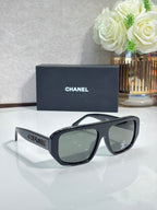 Chanel glasses with dark navy frames and green tinted lenses, side profile