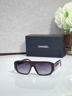 Chanel glasses with burgundy frames and purple tinted lenses, angled front view