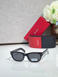 Prada sunglasses with black frame and dark tinted lenses, rounded rectangle shape