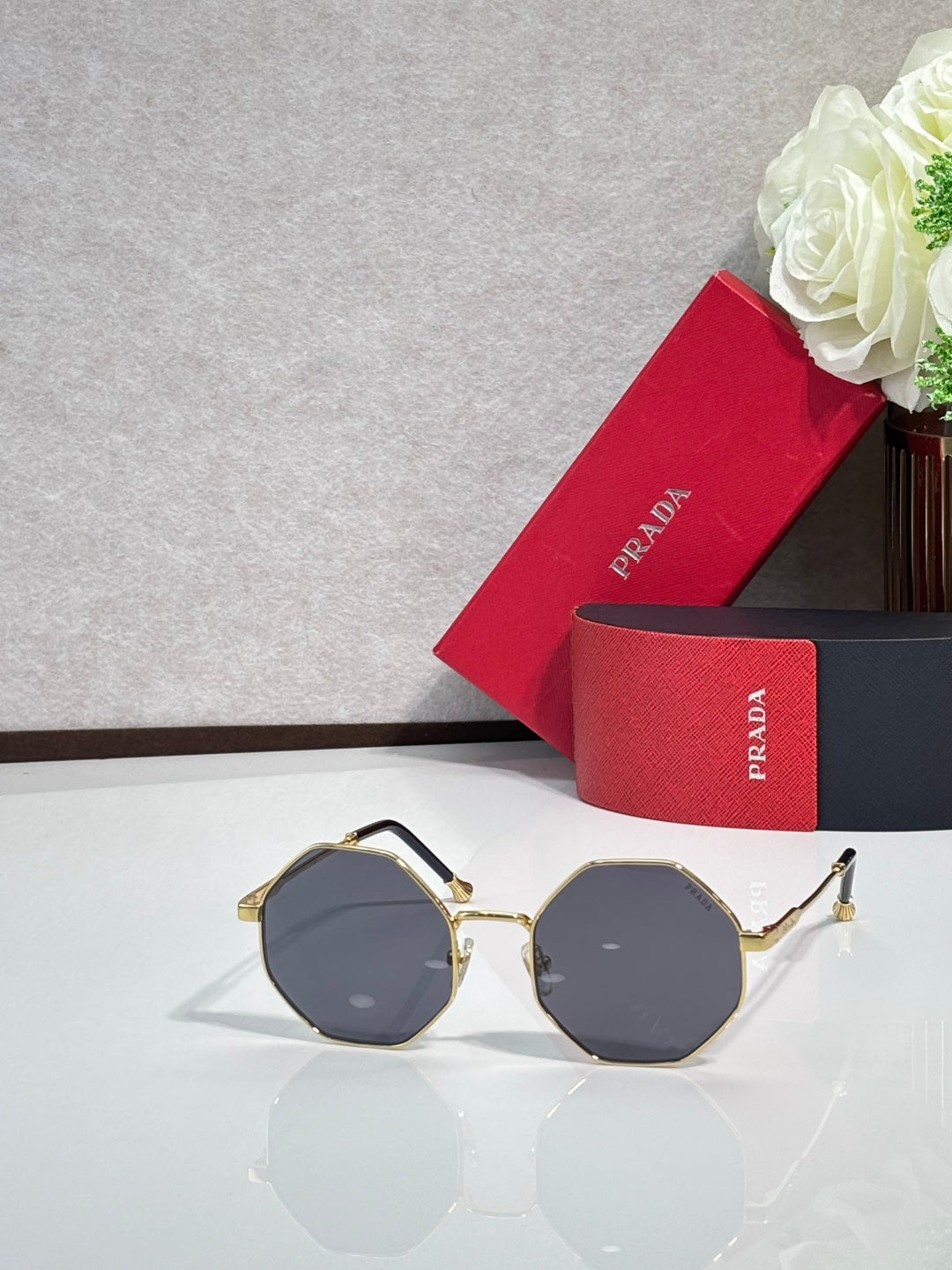 Prada round sunglasses with gold-tone frame and dark gray lenses
