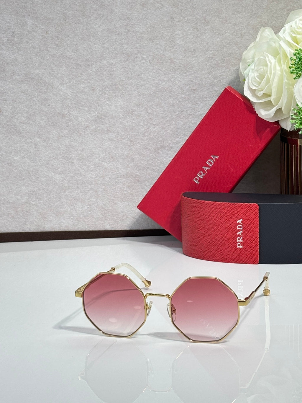 Prada round sunglasses with gold-tone frame and rose-tinted lenses