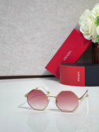 Prada round sunglasses with gold-tone frame and rose-tinted lenses
