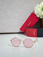 Prada round sunglasses with gold-tone frame and pink-tinted lenses