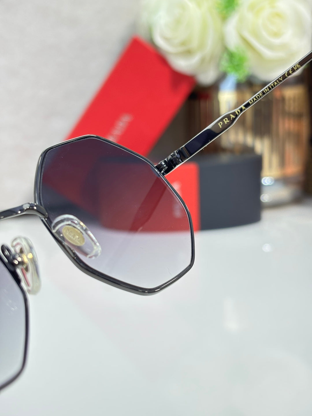 Prada round sunglasses with dark frame and purple-tinted lenses