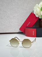 Prada round sunglasses with gold-tone frame and light tinted lenses