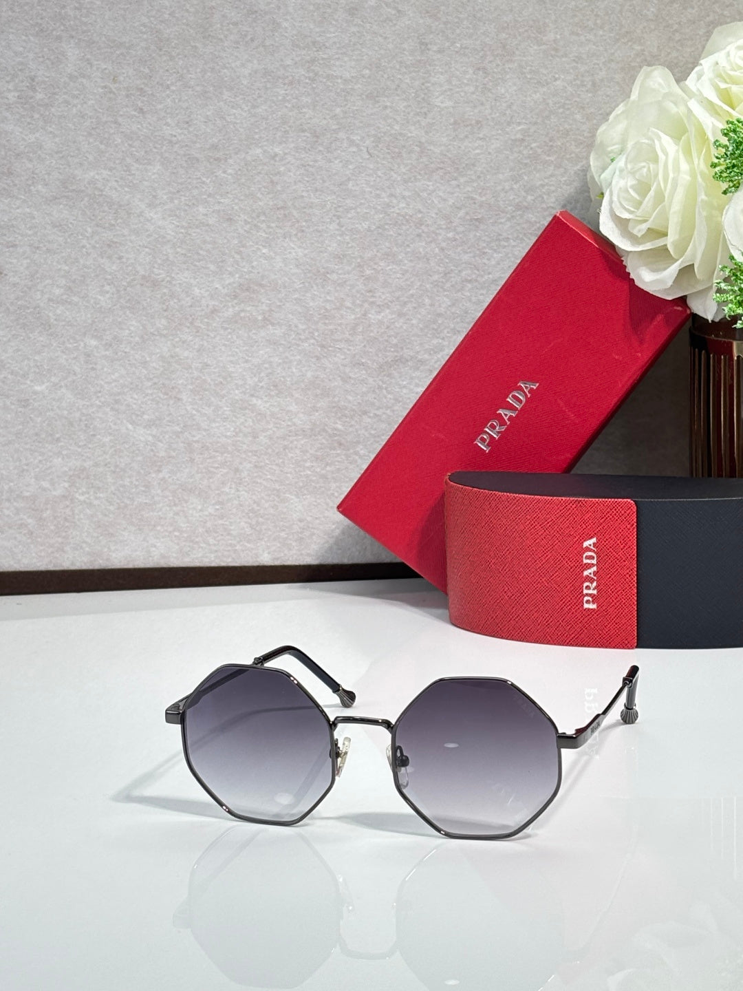Prada round sunglasses with black frame and dark gray lenses