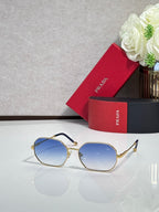 Prada sunglasses with gold-tone frame and blue tinted lenses, rounded square-oval