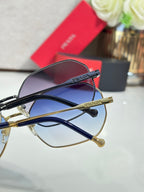 Prada sunglasses side view with dark frame and gold details, tinted lenses