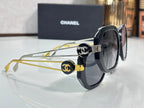 Chanel round cat-eye sunglasses with dark frames, gold arms, and interlocking logo caps