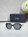 Chanel cat-eye sunglasses with dark tortoise frames and gold-tone logo accents