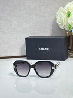 Chanel cat-eye sunglasses with dark frames and gold-tone temple details