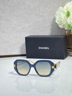Chanel cat-eye sunglasses with blue frames, light lenses, and gold-tone logo hardware